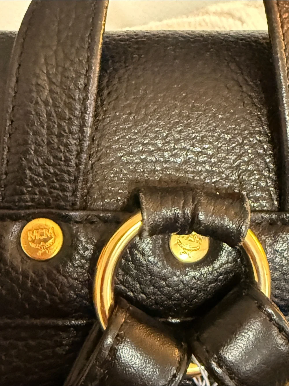 MCM Black Leather Backpack with Gold Accents and Front Pockets